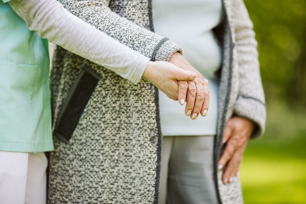 Young hand holding elder one. Help for the elder woman